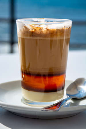 Special coffee of Canarian islands in Spain, sweet barraquito coffee with layers and alcohol served...