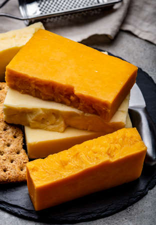 Cheese collection, matured and orange original British cheddar cheese in blocks served with crackers...