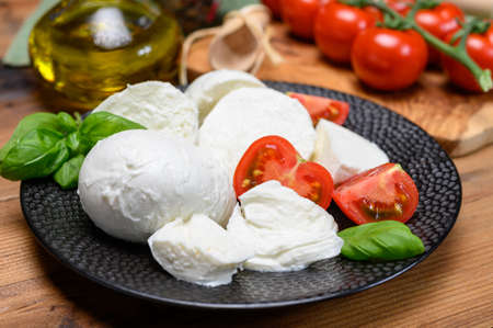 Cheese collection, white mozzarella cheese balls for salad or for appetizer snacks from italian deli shop in New York, USAの写真素材
