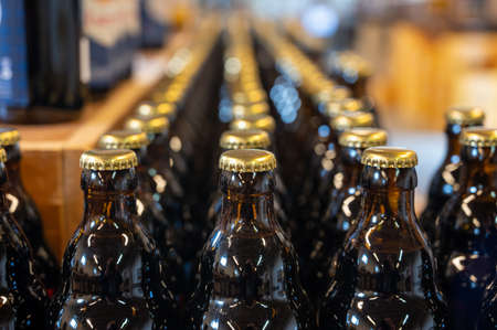 Many Belgian beer bottles in abbey shop close up