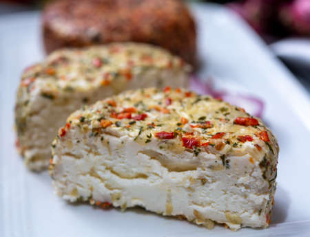 Different french soft goat cheeses made with colorful spices and herbs close upの写真素材