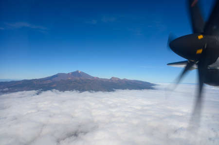 Aerial overcloud view on Tenerife island from airplane, peak of Mount Teideの写真素材
