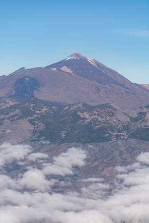 Aerial overcloud view on Tenerife island from airplane, peak of Mount Teideの写真素材