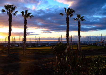 Lifestyle background, many yachts and sail boats in ocean harbour on tropical island on sunriseの写真素材