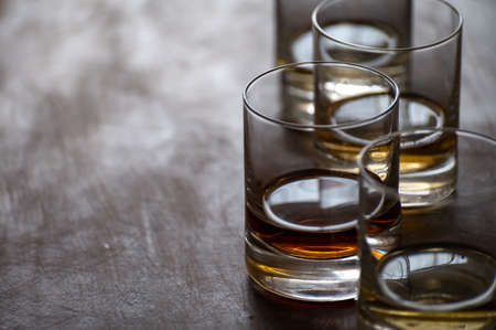 Tasting of flight of Scotch whisky from tumbler glasses in old Edinburgh pub,  Scotland, UK, close upの写真素材