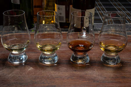 Tasting of flight of Scotch whisky from special tulip-shaped glasses on distillery in Scotland, UK close upの写真素材