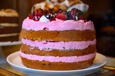 British sweet dessert biscuit cake with pink strawberry cream  and ber
