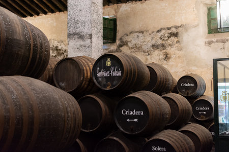 September 3, 2019, El Puerto de Santa Maria, Andalusia, Spain, old bodega with dark wooden barrels with sherry wine, jerez triangleのeditorial素材
