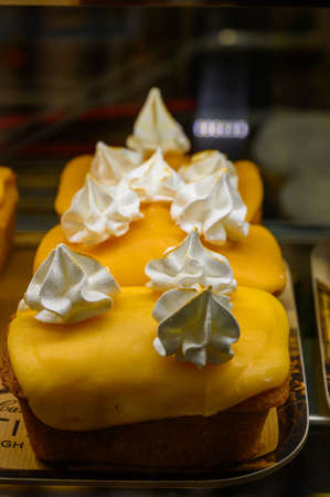 British sweet dessert for coffee, biscuit cakes with orange lemon cream in bakery