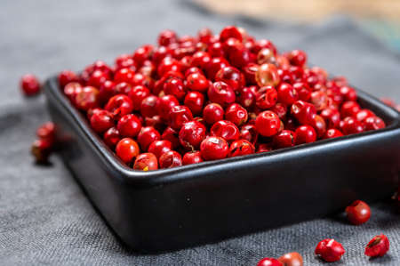 Bowl with dried red round peppers condiment close up