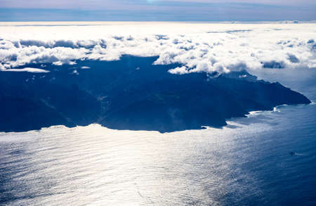 Aerial overcloud view on La Gomera island from airplane, peak of Mount Teideの写真素材