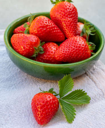 Red ripe organic strawberries in green bowlの写真素材