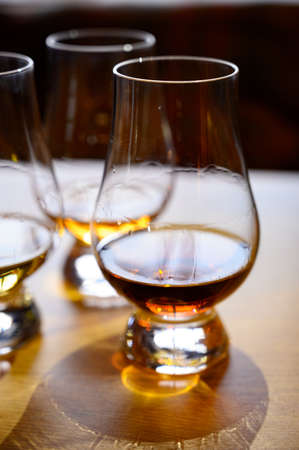 Flight of Scottish whisky, tasting glasses with variety of single malts or blended whiskey spirits on distillery tour in Scotland, UKの写真素材