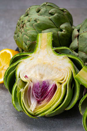 Big ripe uncooked green globe artichoks vegetables close upの写真素材