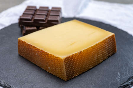 Block of Swiss medium-hard matured cheese gruyere used for baking, quiche, fondue, sandwiches  close...