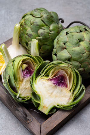 Big ripe uncooked green globe artichoks vegetables close upの写真素材