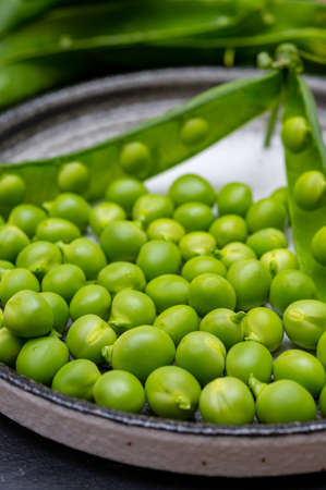 New harvest of fresh ripe green peas legumes