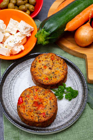 Tasty organic vegetarian food, burgers with Greek feta cheese, sweet red paprika, green olives and zucchiniの写真素材