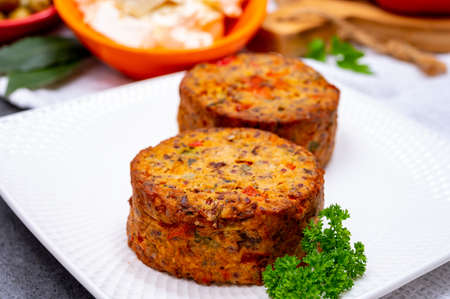 Tasty organic vegetarian food, burgers with Greek feta cheese, sweet red paprika, green olives and...