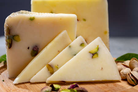 Cheese collection, fresh Italian pecorino cheese made from sheep milk filled with pistachio nuts...