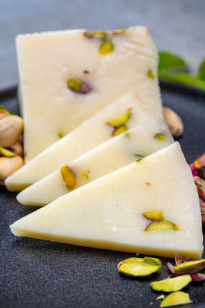 Cheese collection, fresh Italian pecorino cheese made from sheep milk filled with pistachio nuts...