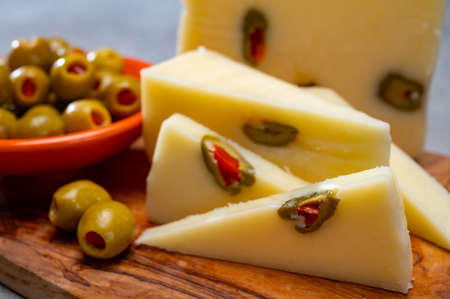 Cheese collection, fresh Italian pecorino cheese made from sheep milk filled with green olives...