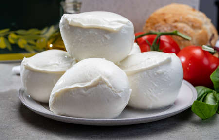 Fresh handmade soft Italian cheese from Campania, white balls of buffalo mozzarella cheese made from cow milk ready to eat close upの写真素材