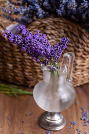 Small vintage vase with bunch of fresh purple  aromatic lavender flowers in gift shop in Provence, France close upの写真素材