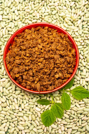 Love vegan and vegetarian food concept, plant based minced meat in plate on soya beans background close upの写真素材