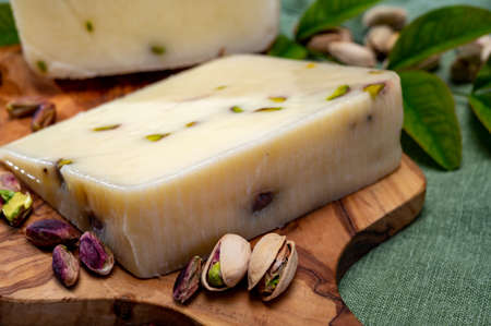 Cheese collection, fresh Italian pecorino cheese made from sheep milk filled with pistachio nuts...