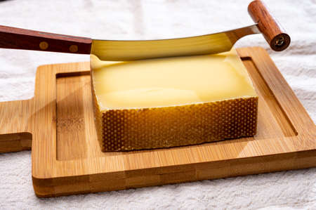 Block of Swiss medium-hard matured cheese gruyere used for baking, quiche, fondue, sandwiches  close upの写真素材