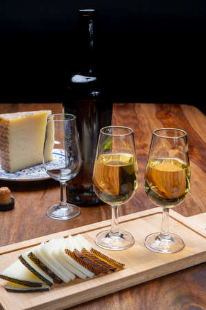 Spanish fino dry sherry wine from Andalusia and pieces of different sheep hard manchego cheeses made...