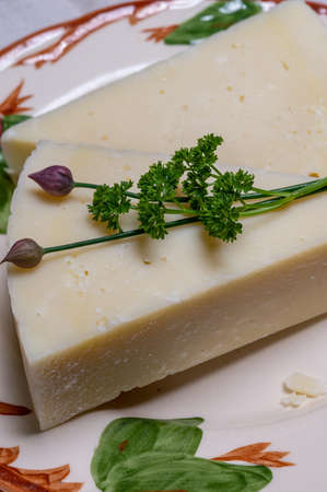 Pieces of matured pecorino romano italian cheese made from sheep milk in Lazio, Sardinia or Tuscany...