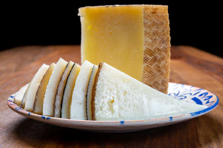 Cheese collection, pieces of different sheep hard manchego cheeses made in La Mancha, Spain served...