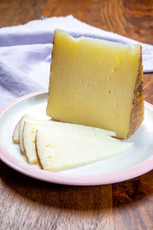 Cheese collection, pieces of different sheep hard manchego cheeses made in La Mancha, Spain served...