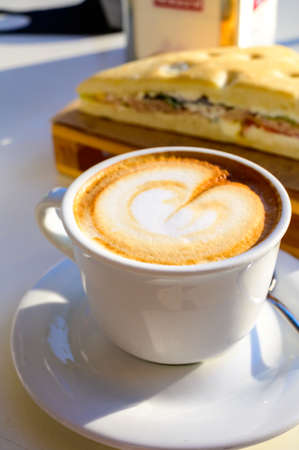 Breakfast coffee, Italian classic cappuccino with milk foam served in cafe close upの写真素材