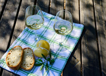 Summer picnic or outdoor lunch with tasting of white wine on green vineyards in Lazio, Italyの写真素材