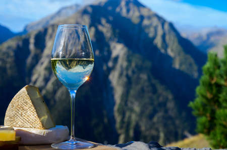 Tasty cheese and wine from Savoy region in France, beaufort, abondance, emmental, tomme and...