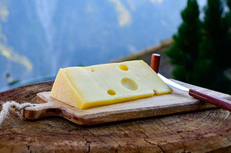 Cheese collection, French emmental de savoie cheese with round holes served outdoor in Savoy region,...