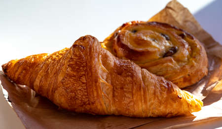 French breakfast in bakery served outdoor, fresh baked croissants and sweet pastry, morning food close upの写真素材