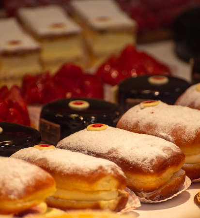 Assortment of french fresh baked sweet pastry with fresh fruits and berries in confectionery shop close upの写真素材