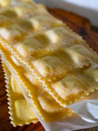 Handmade uncooked fresh ravioli with four cheeses filling, tasty vegetarian food close upの写真素材