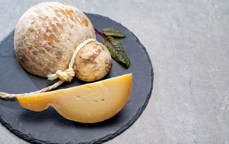Italian semi hard matured caciocavallo cheese, handmade and aged in natural underground caves in...