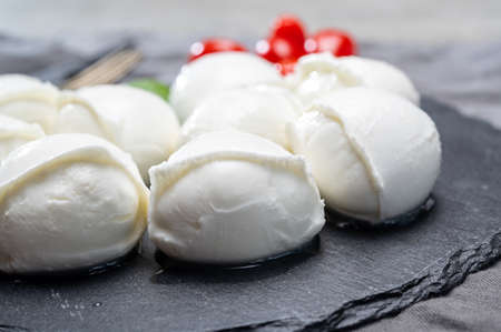 Tasty italian food, fresh white buffalo mozzarella soft cheese balls from Campania close up