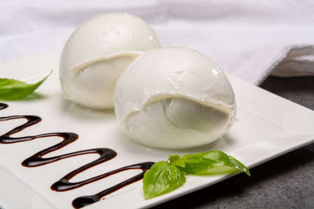 Ð¡heese collection, balls on soft white mozzarella bufala cheese served with balsamic cream and...
