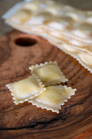 Handmade uncooked fresh ravioli with four cheeses filling, tasty vegetarian food close upの写真素材