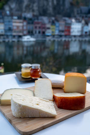 Cheese collection, tasty Belgian abbey cheeses made with brown beer and fine herbs and view on Maas...
