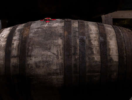 Old porto lodge with rows of oak wooden casks for slow aging of fortified ruby or tawny porto wine in Vila Nova de Gaia, north of Portugalの写真素材
