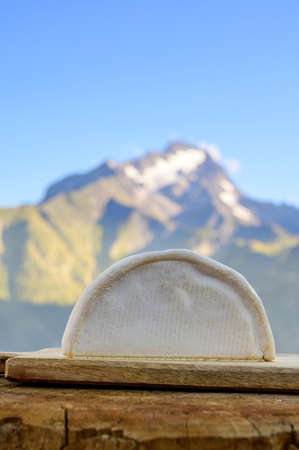 Cheese collection, French reblochon de savoie gratin cheese served outdoor with Alpine mountains peaks in summer on backgroundの写真素材