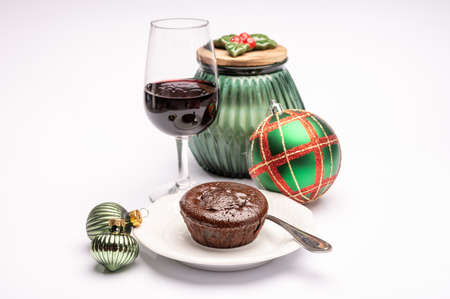 Popular british christmas food, glass of vintage ruby port wine and hot chocolate cake with christmas decoration on background isolated on whiteの写真素材